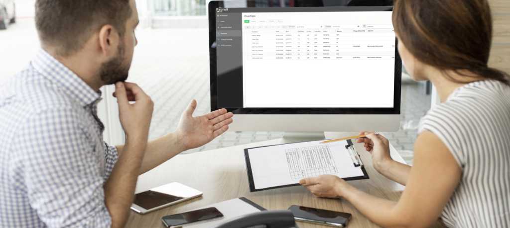HR specialist computing payroll on a laptop using ZKTeco Payroll